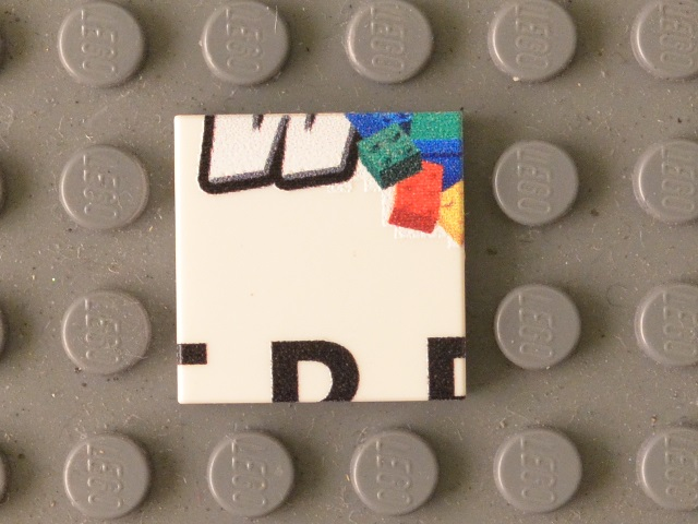 Lego Tile 2 x 2 with Black 'W' Lower Half, Bricks, and Partial 'TRE' Pattern
