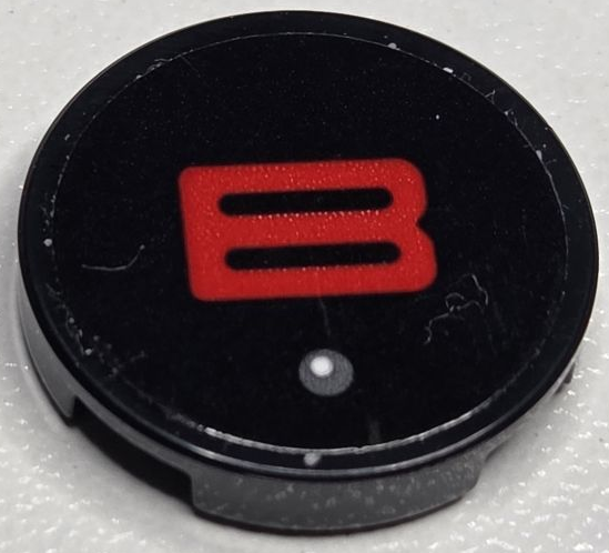 Lego Tile, Round 2 x 2 with Bottom Stud Holder with Red Capital Letter B and Dark Bluish Gray Dot with White Highlight Pattern (Sticker) - Set 40769 / Black