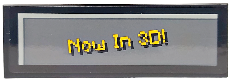 Lego Tile 2 x 6 with Pixelated Bright Light Orange 'Now In 3D!' on Dark Bluish Gray Background Pattern (Sticker) - Set 21265