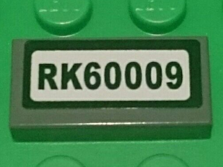 Lego Tile 1 x 2 with 'RK60009' Pattern (Sticker) - Set 60009 / Dark Bluish Gray