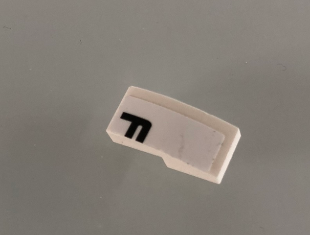 Lego Slope, Curved 2 x 1 x 2/3 with Black Letter F on White Background Pattern Model Right Side (Sticker) - Set 42096