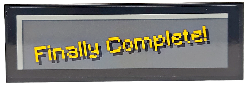 Lego Tile 2 x 6 with Pixelated Bright Light Orange 'Finally Complete!' on Dark Bluish Gray Background Pattern (Sticker) - Set 21265 / Black