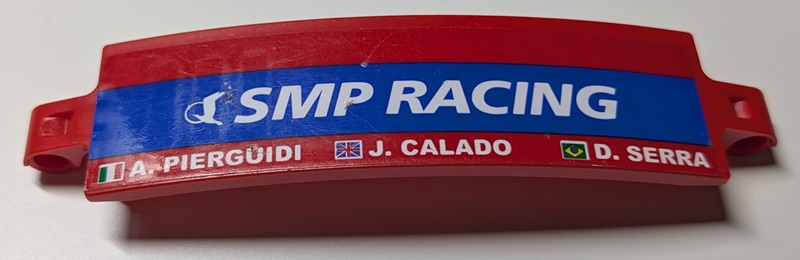 Lego Technic, Panel Curved 3 x 13 with White 'SMP RACING' on Blue Stripe, 'A. PIERGUIDI', 'J. CALADO', 'D. SERRA', Italian, United Kingdom Union Jack and Brazilian Flags Pattern Model Left Side (Sticker) - Set 42125