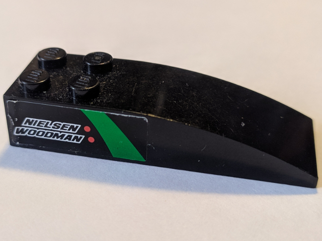 Lego Slope, Curved 6 x 2 with 'NIELSEN WOODMAN' Pattern Model Left Side (Sticker) - Set 8184 / Black