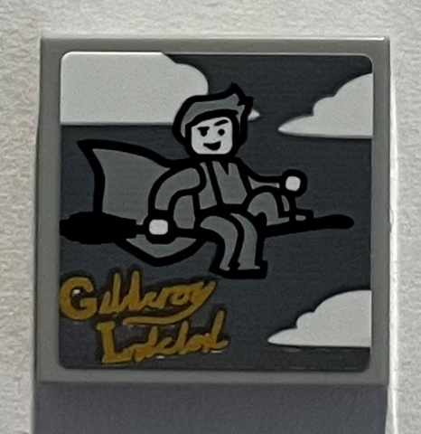 Lego Tile 2 x 2 with Clouds, Minifigure on Broom, Gold Script 'Gilderoy Lockhart' Pattern (Sticker) - Set 76389 / Light Bluish Gray