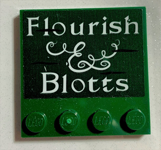 Lego Tile, Modified 4 x 4 with Studs on Edge with 'Flourish & Blotts' Pattern (Sticker) - Set 75978