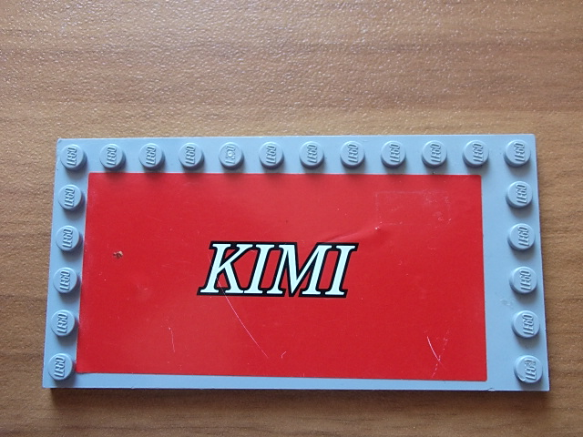 Lego Tile, Modified 6 x 12 with Studs on Edges with White 'KIMI' on Red Background Pattern (Sticker) - Set 8144-2 / Light Bluish Gray