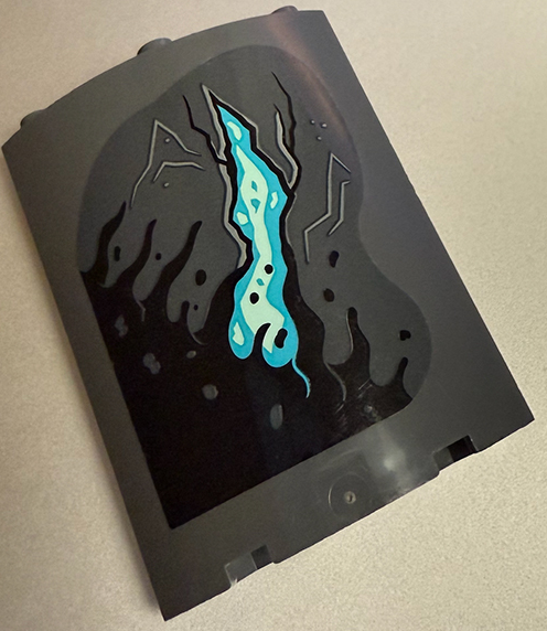 Lego Cylinder Quarter 4 x 4 x 6 with Black Slime, Cracks and Medium Azure Lava Pattern Model Left Side (Sticker) - Set 70437