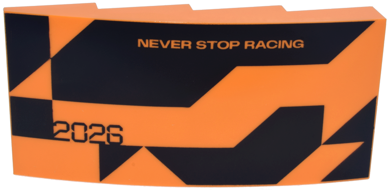 Lego Slope, Curved 8 x 4 x 1 2/3 with Black Triangle, Angled Shapes and Stylized '2026', 'NEVER STOP RACING' Pattern Model Left Side