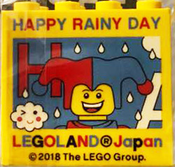 Lego Brick 2 x 4 x 3 with LEGOLAND Japan, 'HAPPY RAINY DAY', Jester Minifigure, and Red Capital Letter H Pattern / Yellow