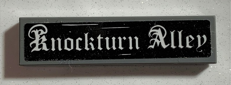 Lego Tile 1 x 4 with White 'Knockturn Alley' on Black Background Pattern (Sticker) - Set 75978 / Dark Bluish Gray