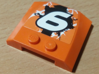 Lego Wedge 4 x 4 x 2/3 Triple Curved with White Number 6 and Black, Orange and White Splatter Pattern (Sticker) - Set 42007