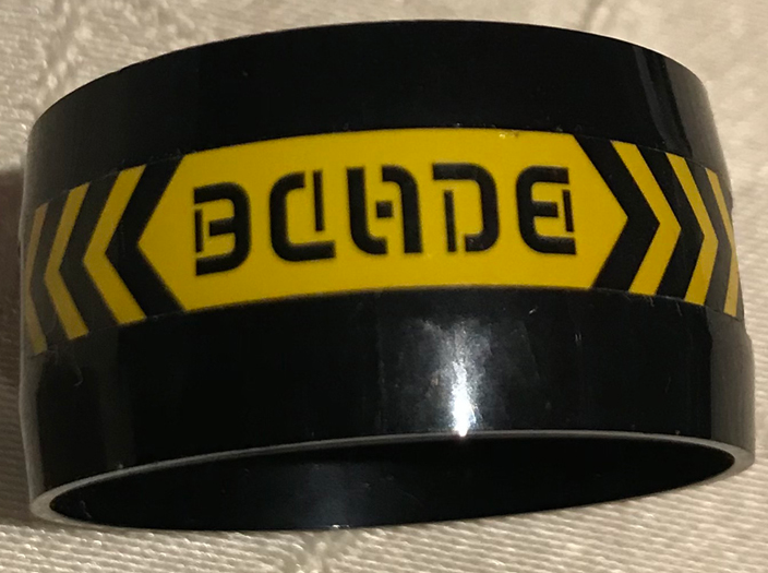 Lego Cylinder 4 x 4 x 1 2/3 with Pin Holes and Center Bar with Stylized 'BLADE' and Black and Yellow Danger Chevrons Pattern (Sticker) - Set 70596 / Black