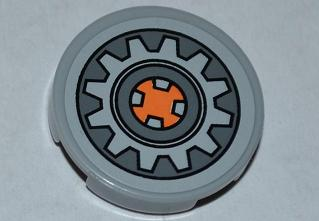Lego Tile, Round 2 x 2 with Gear Wheel with Orange Center on Dark Bluish Gray Background Pattern (Sticker) - Set 9444