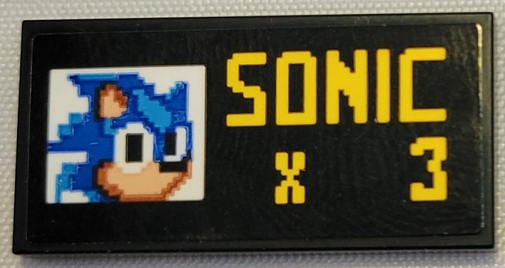 Lego Tile 2 x 4 with Pixelated Sonic the Hedgehog Head and Yellow 'SONIC x 3' Pattern (Sticker) - Set 21331 / Black