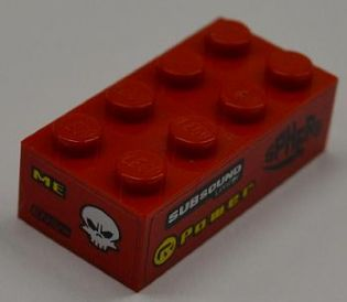 Lego Brick 2 x 4 with 'SUBSOUND LIMITER', 'POWER' and 'SPHERE' on Right Side and 'ME', 'ENGYNE' and White Skull on End Pattern (Stickers) - Set 8186 / Red