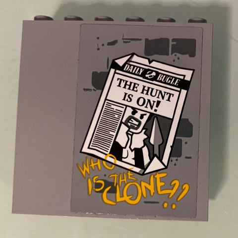 Lego Panel 1 x 6 x 5 with 'DAILY BUGLE' Newspaper Page, 'THE HUNT IS ON!' Headline and 'WHO IS THE CLONE??' Pattern (Sticker) - Set 76057 / Light Bluish Gray