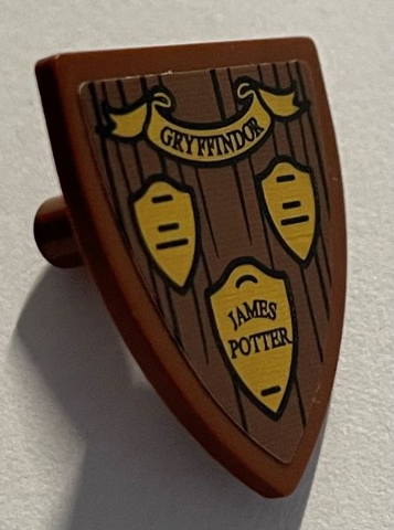 Lego Minifigure, Shield Triangular Short with 'GRYFFINDOR' Banner, 'JAMES POTTER' Plaque on Wood Grain Background Pattern (Sticker) - Set 76395 / Reddish Brown