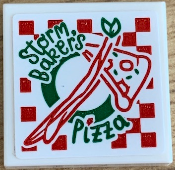 Lego Tile 2 x 2 with Green and Red 'Storm Baker's Pizza' Box Pattern (Sticker) - Set 76200