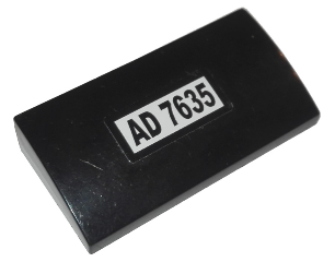 Lego Slope, Curved 2 x 4 x 2/3 with Bottom Tubes with 'AD 7635' Pattern (Sticker) - Set 7635 / Black