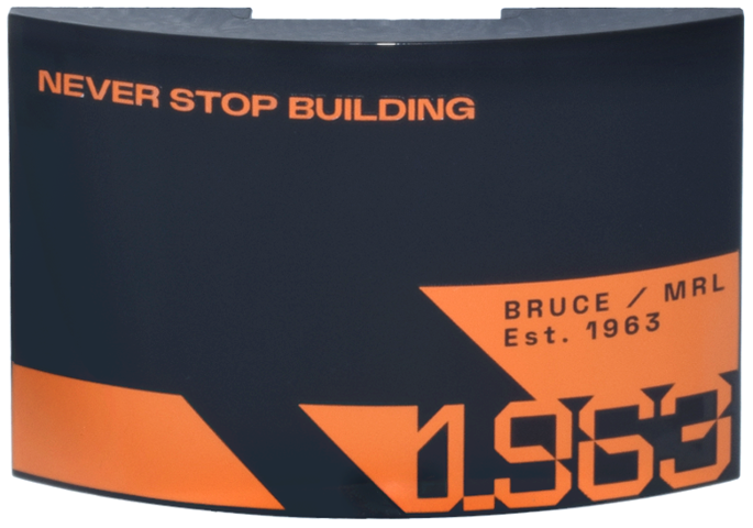 Lego Slope, Curved 6 x 4 Double with Orange 'NEVER STOP BUILDING', Stylized '1963', Triangle and Trapezoids, 'BRUCE / MRL Est. 1963' Pattern Model Right Side