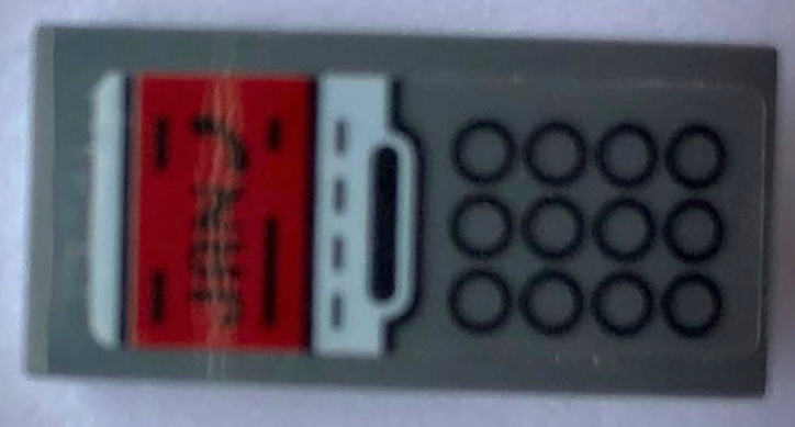 Lego Slope, Curved 2 x 1 x 2/3 with Telephone with 12 Black Circles Keypad and Red Screen with 'JAN' Pattern (Sticker) - Set 21336 / Dark Bluish Gray