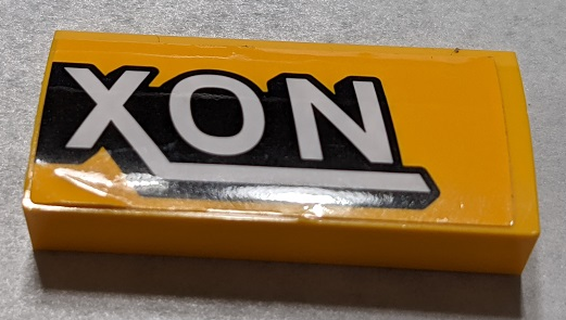 Lego Slope, Curved 2 x 4 x 2/3 with Bottom Tubes with Black and White 'XON' Pattern Side B (Sticker) - Set 76067