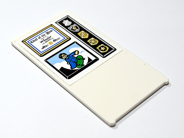 Lego Glass for Window 1 x 4 x 6 with 'Chief of the Year Wheeler' Certificate in Frame, Gold Police Badges and Minifigure on Green Skateboard Pattern (Sticker) - Set 60246 / White