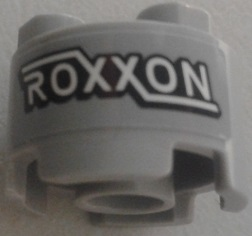 Lego Brick, Round 2 x 2 with Axle Hole with 'ROXXON' Pattern (Sticker) - Set 76067 / Light Bluish Gray