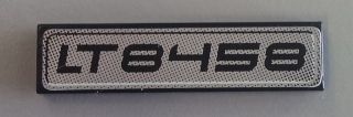 Lego Tile 1 x 4 with Black 'LT8458' Pattern on Silver Background (Sticker) - Set 8458 / Black