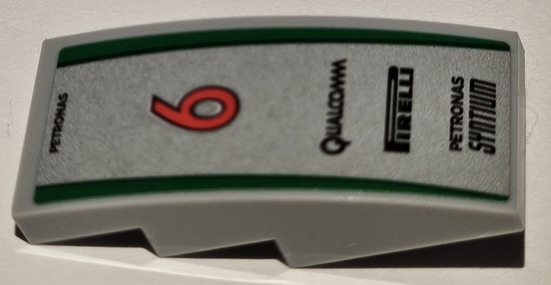 Lego Slope, Curved 4 x 2 with Black 'QUALCOMM', 'PIRELLI', and 'PETRONAS SYNTIUM', Red Number 6 and Green Stripes on Silver Background Pattern (Sticker) - Set 75883