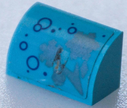 Lego Slope, Curved 1 x 2 with Bottom Stud Holder with Dark Blue Circles and Metallic Light Blue Snowflakes Pattern Model Right Side (Sticker) - Set 41168