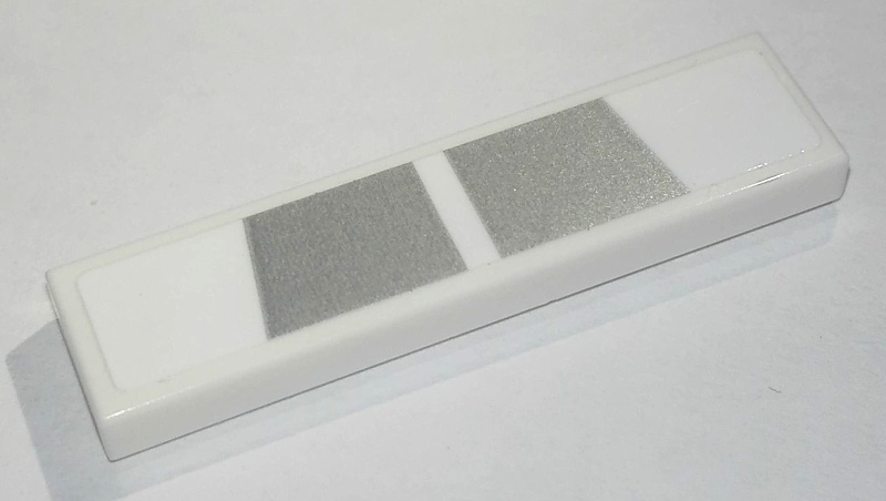 Lego Tile 1 x 4 with 2 Silver Trapezoids Pattern (Sticker) - Set 76900