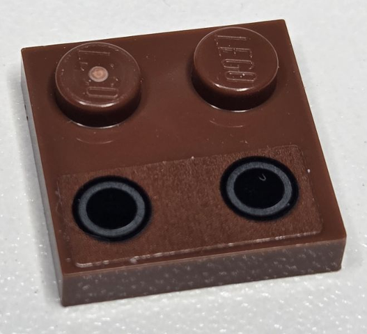 Lego Tile, Modified 2 x 2 with Studs on Edge with Dark Bluish Gray Rings on Black Circles Pattern (Sticker) - Set 75381 / Reddish Brown