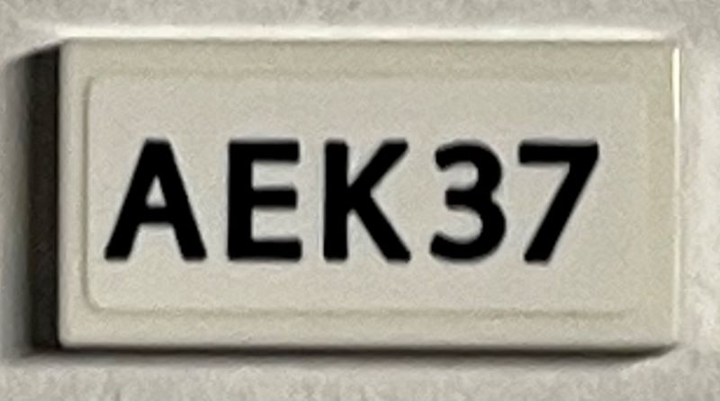 Lego Tile 1 x 2 with Black 'AEK37' Pattern (Sticker) - Set 21330 / White