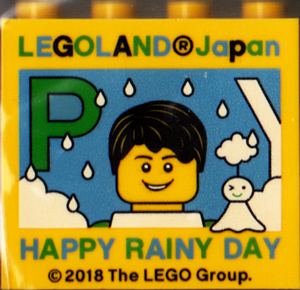 Lego Brick 2 x 4 x 3 with LEGOLAND Japan, 'HAPPY RAINY DAY', Male Minifigure, and Green Capital Letter P Pattern
