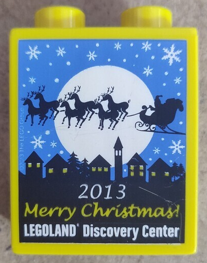Lego Duplo, Brick 1 x 2 x 2 with LEGOLAND Discovery Center, '2013 Merry Christmas!', Moon, Snowflakes, Skyline, and Santa's Sleigh with Reindeer Pattern / Yellow