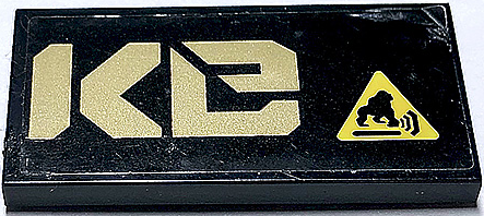 Lego Tile 2 x 4 with Gold 'Ke' (QUAKe Right Half) and Gorilla Warning Sign Pattern (Sticker) - Set 70632