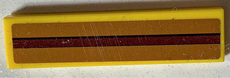 Lego Tile 1 x 4 with Dark Brown Stripe on Medium Nougat Background Pattern (Sticker) - Set 75978