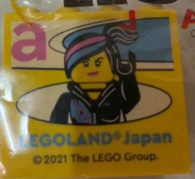 Lego Brick 2 x 4 x 3 with LEGOLAND Japan, Wyldstyle Minifigure, and Dark Pink Lowercase Letter a Pattern